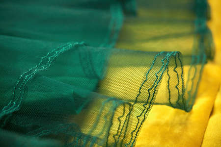Green children's dress for girls, close-up details, soft selective selective focus. Clothes for holidays and various events.の写真素材