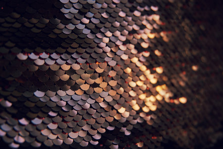 Glamorous background of multi-colored sequins, sequins. Sequins on the fabric, selective selective soft focus. Sparkles shimmer in the sun.の写真素材