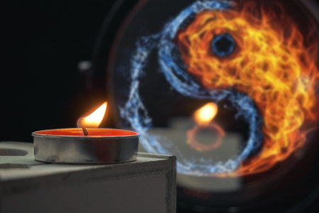 A burned candle stands on a wooden stand, against the background of a mirror in which water and fire...