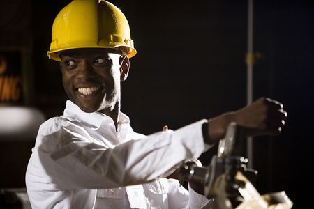 Close up of African American man wearing a hard hatの写真素材