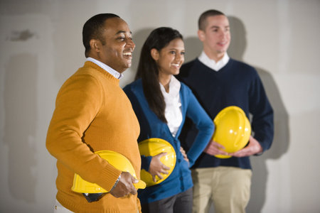 Multi-ethnic men and woman in empty commercial office space ready for buildoutの写真素材