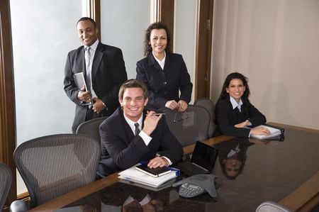 Young businessman with Hispanic businesswomen and African American male colleagueの写真素材