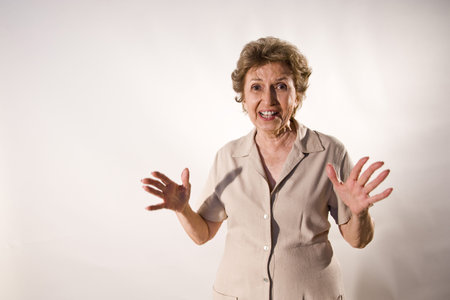 Excited senior woman in her 70s with wide grin