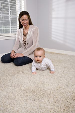 Mother with six month old baby at homeの写真素材