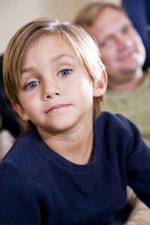 Face of cute 5 year old little boy with father watching in backgroundの写真素材