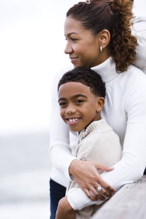 Close-up of African-American mother and son at beachの写真素材