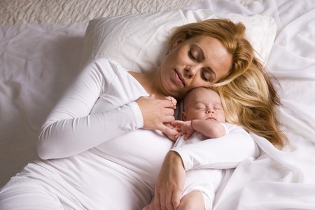 Mother holding one month old baby boy in her armsの写真素材