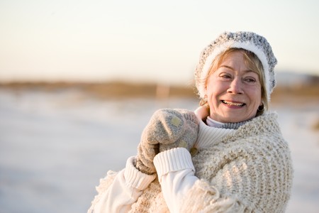 Portrait of senior woman wearing warm winter hat, sweater and glovesの写真素材