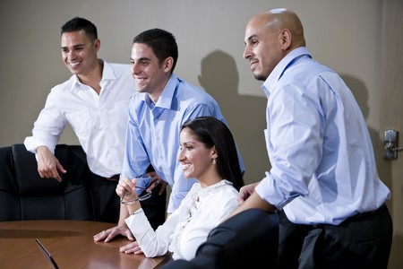 Hispanic office workers in boardroom watching presentationの写真素材