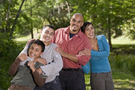 Portrait of Hispanic father and two boys outdoors in outdoor parkの写真素材