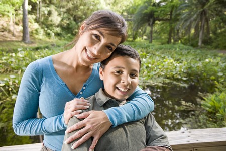 Portrait of Hispanic mother and 10 year old son outdoors in parkの写真素材