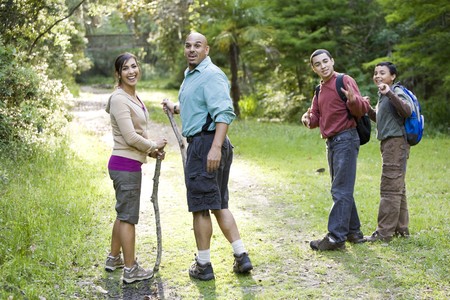 Hispanic family with two boys hiking in woods on trailの写真素材