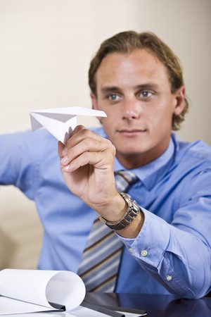 Businessman playing with paper airplaneの写真素材