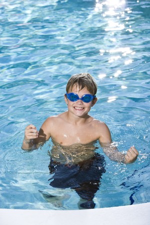 Boy, 9 years, having fun in swimming poolの写真素材