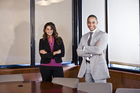 African American businessman and Indian businesswoman meeting in office boardroomの写真素材