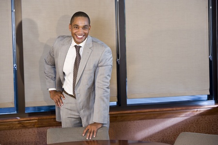 Professional worker standing in boardroom, African American, 30sの写真素材