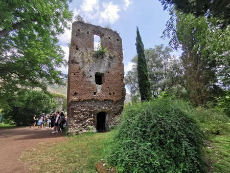 Tourists visiting the ruins of the medieval castle of San Francesco in Lazio, Italyの写真素材