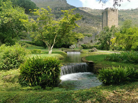 Waterfall and castle in the village of Girona, Catalonia, Spainの写真素材