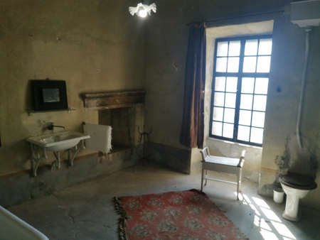 Interior of an old house with a window and a white chairの写真素材