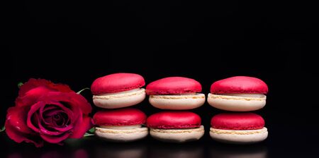 macaroons.red macaroons on black background with red rose for Valentines dayの写真素材