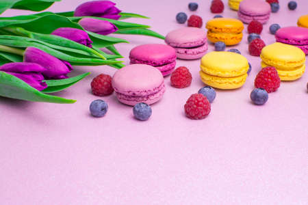 colorful background with berry and flowers and macaroonsの写真素材