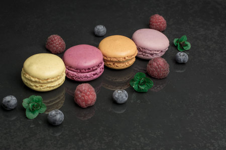 colorful macaroons on black background