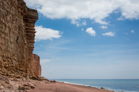 Rocky coast of the Black Sea against the blue sky and white clouds.の写真素材