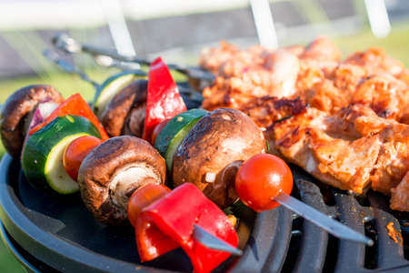 grillet meat and vegetables on grill in campsiteの写真素材