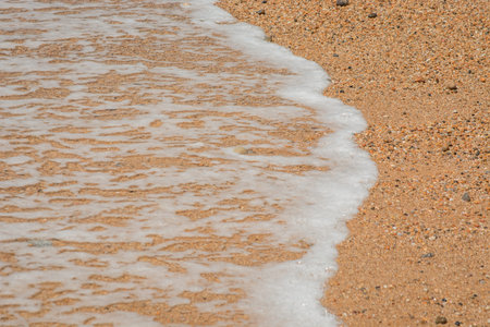 Colorful sea stones background with waves