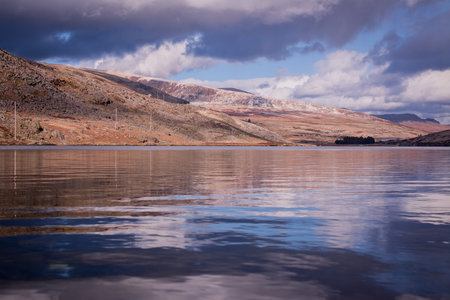 A moody landscape of the lakes Snowdonia National Park in Wales, UK