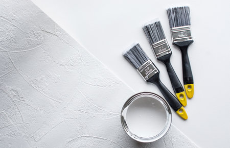 tin paint can and new paintbrush on white backgroundの写真素材