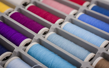 Colourful sewing threads background closeup