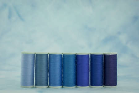 Colourful sewing threads background closeupの写真素材