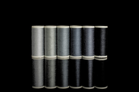 Colourful sewing threads background closeup