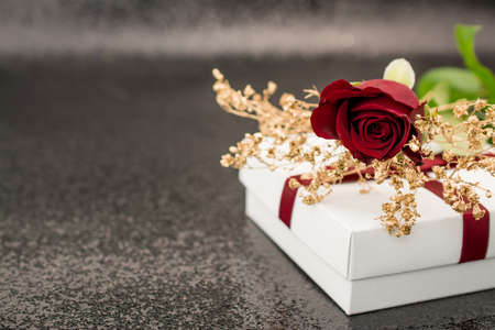 black background with  gift box and red roseの写真素材