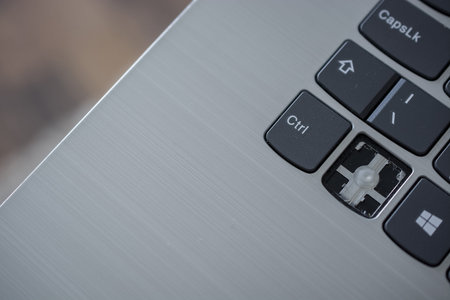 Close-up of a keypad of a modern laptop with a button.