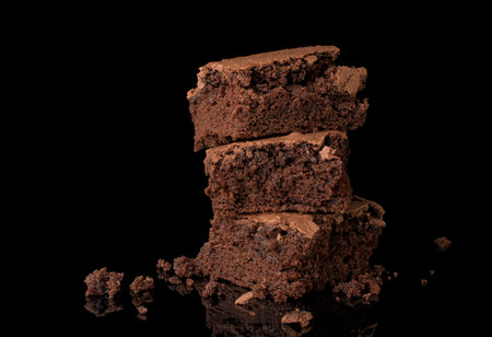 Pieces of chocolate cake on a black background, close-upの写真素材