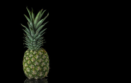 Pineapple on a black background with copy space. Tropical fruit.の写真素材