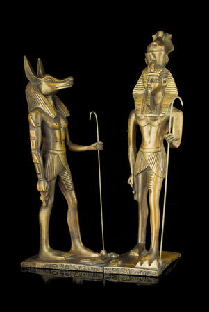 Ancient Egyptian statue on the black background