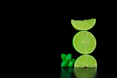 Still life, lemon and lime on black background