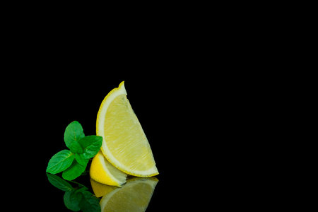 Still life, lemon and lime on black backgroundの写真素材
