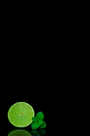 Fresh lime and mint on a black background with space for text.の写真素材