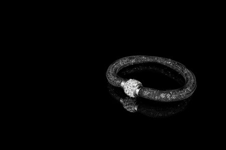 abstract black bracelet on dark background texture