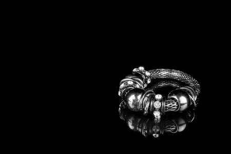 abstract black bracelet on dark background textureの写真素材