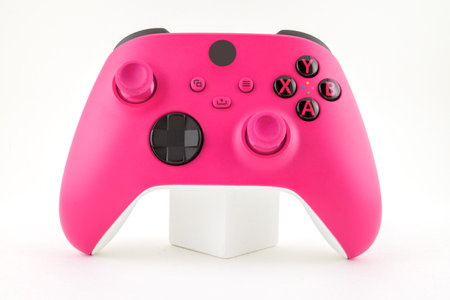 pink video game controller isolated on white background with clipping path.