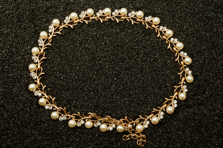 golden jewellery with diamonds over black background