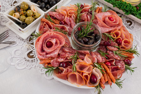Antipasto platter with prosciutto, salami and olivesの写真素材