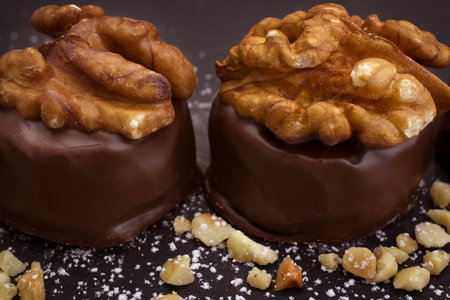 Delicious chocolate candies with walnuts on a black background.の写真素材