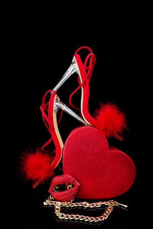 Red heart on a black background with accessories for Valentine's Day.の写真素材