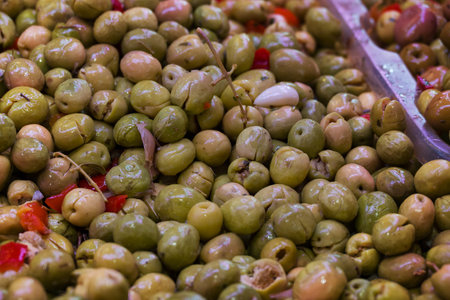 Green olives on the counter in the market, close-upの写真素材